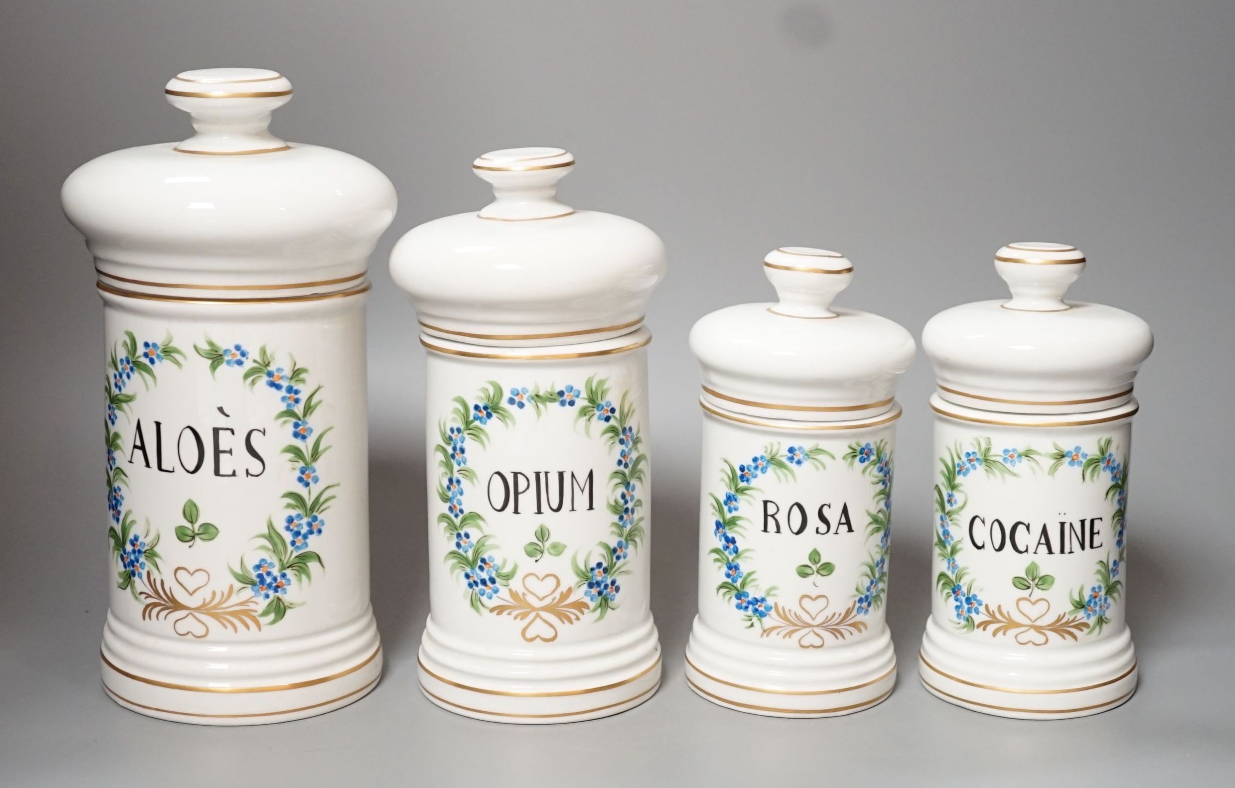 Four graduated porcelain apothecary jars - tallest 26cm